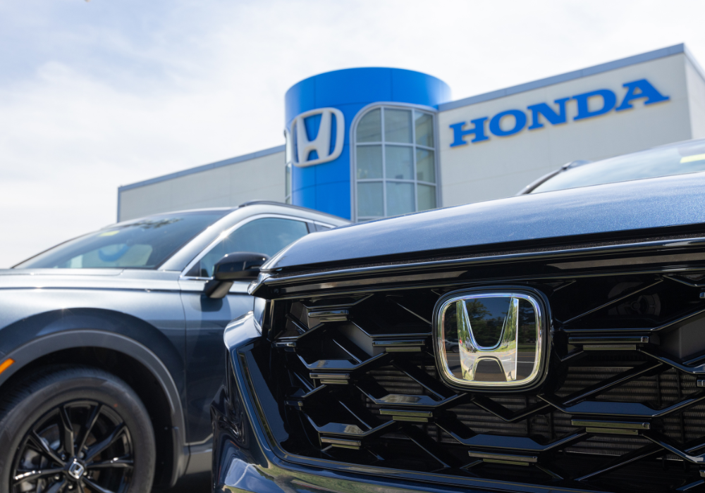Close up of the front grille Honda SUV parked in front of a Honda dealership